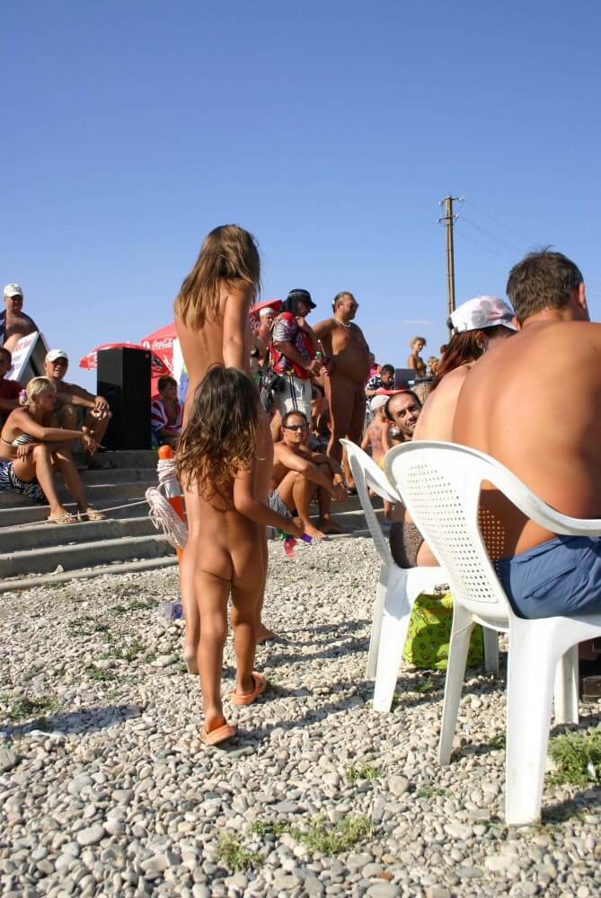 Naturist Standing Sideline - A nudist promotes tolerance and respect for others